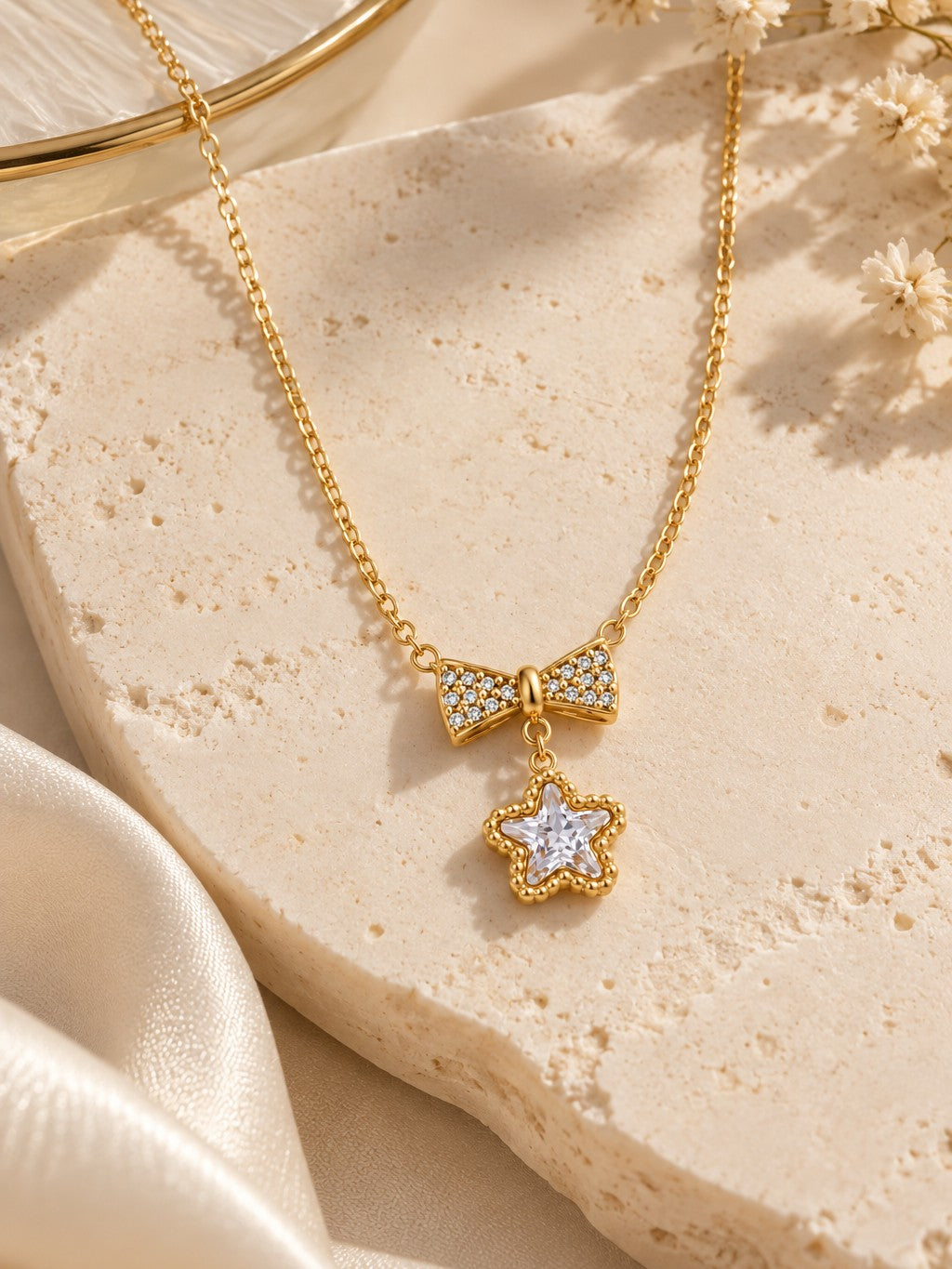 Bow Star Pendant Necklace – flat lay – Pabeena