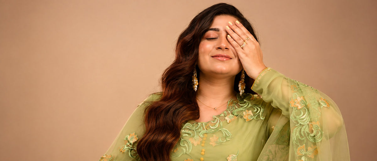 Pabeena kundan pearl jhumkas and a gold-plated ring worn with a green suit