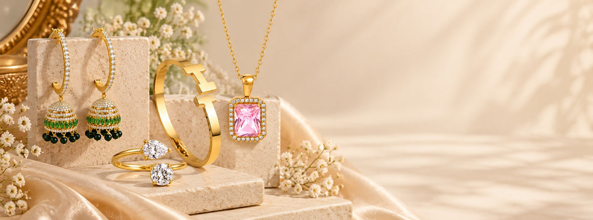 Pabeena green meenakari jhumka hoops, a gold-plated bangle, a pink stone pendant and two solitaire rings