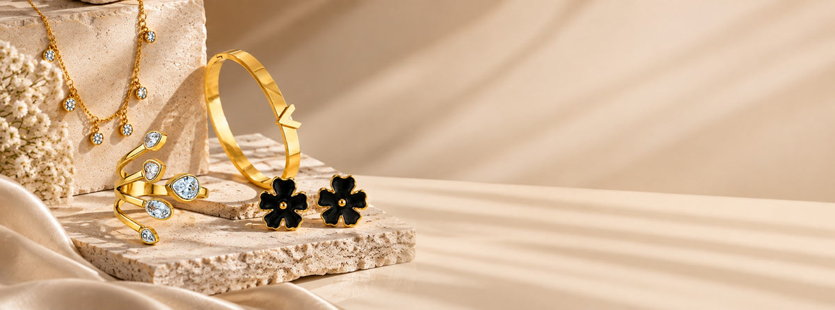 Pabeena gold-plated station necklace, a stone spiral ring, a plain bangle and black flower studs